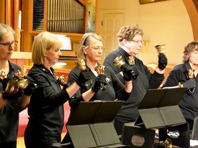 Women performing with bells in service