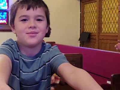 Little boy taking a selfie inside the church